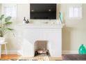 White brick fireplace with wood mantel in living room at 3200 N Fillmore St, Denver, CO 80205