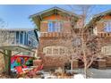 Side exterior view displaying the brick architecture and the outdoor seating area at 861 N Humboldt St # A, Denver, CO 80218