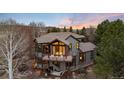 Aerial view of home with a deck, mountain views, outdoor fireplace, and hammock at 2 Twin Flower, Littleton, CO 80127