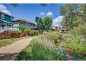 The backyard is bordered by a creek, wooden fence, and mature trees, offering a secluded outdoor space at 1839 Caleta Trl, Longmont, CO 80504