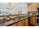 Kitchen area featuring granite countertops, tile backsplash, and stainless steel sink at 6687 S Forest Way # E, Centennial, CO 80121
