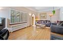 Bright living room with hardwood floors and neutral walls featuring large windows and comfortable seating at 2995 Albion St, Denver, CO 80207