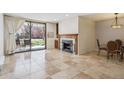 Bright living room features a fireplace and sliding doors to the patio at 13950 E Oxford Pl # B105, Aurora, CO 80014