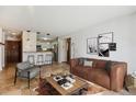 Open living space featuring bar seating, modern lighting and updated flooring at 13950 E Oxford Pl # B105, Aurora, CO 80014