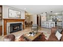 Inviting living room boasts a cozy fireplace, dining area, and breakfast bar with modern pendant lighting at 13950 E Oxford Pl # B105, Aurora, CO 80014
