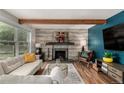 The living room offers a cozy fireplace, wood beam, and a comfortable seating area to enjoy at 1152 S Yosemite Way # 29, Denver, CO 80247