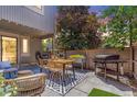 Charming outdoor patio with a wood table, seating, grill, stylish rug, and string lights creating the perfect outdoor space at 1152 S Yosemite Way # 29, Denver, CO 80247