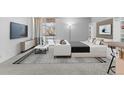 Bright living room with a balcony access, sleek furniture, and minimalist decor enhance the open and airy feel of the space at 2500 S York St # 310, Denver, CO 80210