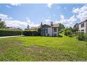 Spacious yard featuring lush lawn, mature trees, and classic architecture at 675 Holland St, Lakewood, CO 80215