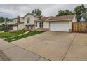 Inviting two-story home with an expansive driveway leading to a two-car garage and a well-maintained lawn at 380 S 25Th Ave, Brighton, CO 80601