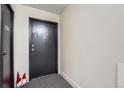 Hallway featuring a unit door with a black door and gray flooring at 1313 Steele St # 606, Denver, CO 80206