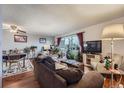 Bright condo living room with hardwood floors, large window, and comfortable furniture at 1313 Steele St # 606, Denver, CO 80206