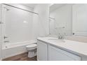 Clean bathroom featuring a tiled shower/tub and a single sink vanity with white cabinets at 9141 Telluride Ct, Commerce City, CO 80022