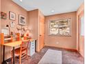 Cozy study room with a desk, neutral walls, natural light, and unique tiled floors at 30813 Kings Valley Dr, Conifer, CO 80433