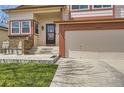 Inviting home exterior with a cozy front porch, well-maintained lawn, and convenient two-car garage at 6367 Xavier St, Arvada, CO 80003
