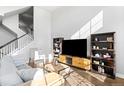 Bright living area showcasing lots of light, with a staircase and modern decor at 2366 Central Park Blvd, Denver, CO 80238