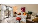 Bright and inviting living room with sliding glass doors to the patio and comfortable seating at 4028 Ames St, Wheat Ridge, CO 80212
