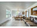 Bright living room with wood floors, large windows, and elegant dining chandelier at 234 Carroll Ln, Breckenridge, CO 80424
