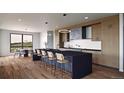 Open concept kitchen features a large island with seating and modern appliances next to the breakfast nook at 5326 Lions Paw St, Castle Rock, CO 80104