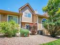Beautiful backyard showcasing a grassy area with trees, shrubbery, and beige siding at 5976 S Jellison St # E, Littleton, CO 80123