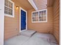 Welcoming entrance with a vivid blue door, complemented by natural lighting and a neutral exterior at 5976 S Jellison St # E, Littleton, CO 80123