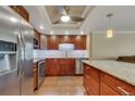 A well-lit kitchen featuring stainless steel appliances, wooden cabinetry, and granite countertops at 13961 E Marina Dr # 314, Aurora, CO 80014