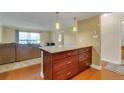 Open-concept view of living room and kitchen featuring recessed lighting, breakfast bar, and contemporary decor at 13961 E Marina Dr # 314, Aurora, CO 80014