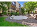 Exterior of building, showcasing a patio and walkway with mature trees and manicured lawn at 7040 E Girard Ave # 207, Denver, CO 80224