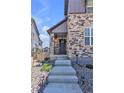 Inviting townhouse entrance featuring stone accents and well-maintained landscaping at 8145 Monte Vista Cir, Littleton, CO 80125
