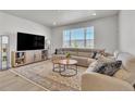 Cozy living room featuring a plush sectional sofa, stylish decor, and lots of natural light at 8145 Monte Vista Cir, Littleton, CO 80125