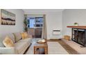 Well-lit living room featuring a fireplace and access to a balcony at 4110 Hale Pkwy Pkwy # 4J, Denver, CO 80220
