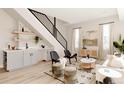 Stylish living room featuring a wet bar, modern decor, and staircase at 8260 E 36Th Ave # 29, Denver, CO 80238