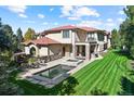 Private backyard with swimming pool, hot tub, manicured lawn, and patio seating area at 2 Viking Dr, Englewood, CO 80113