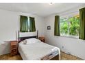 Bright bedroom with natural light, neutral walls, and vintage-style furnishings at 3018 S Depew St, Denver, CO 80227