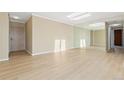 Bright living room with modern flooring and mirrored wall at 2880 S Locust St # 708S, Denver, CO 80222