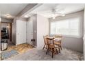 Bright dining area featuring a ceiling fan and a window view, next to the entry way at 2296 S Pitkin Way # A, Aurora, CO 80013