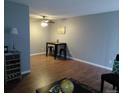 Living room and dining area with modern ceiling fan and hardwood flooring at 10792 E Exposition Ave Ave # 254, Aurora, CO 80012