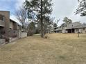 Lush lawn area, partially fenced, provides a peaceful outdoor space at 6475 S Arapahoe Way, Littleton, CO 80120