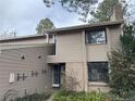 Attractive townhome featuring a welcoming entrance and beige-colored siding at 6475 S Arapahoe Way, Littleton, CO 80120