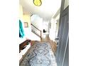 Bright entryway with hardwood floors, a staircase, and a bench with storage baskets at 2831 Shadow Lake Rd, Lafayette, CO 80026