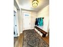 Inviting entryway featuring a bench, coat rack, and a patterned rug on wood flooring at 2831 Shadow Lake Rd, Lafayette, CO 80026