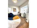 Cozy home office with a desk, chair, blue sofa, and ample natural light at 2831 Shadow Lake Rd, Lafayette, CO 80026