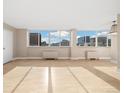 Bright, open living room with hardwood floors and large windows offering city views at 1196 N Grant St # 501, Denver, CO 80203