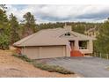 Charming home with a two-car garage, tiled roof, and an inviting entrance with well-maintained landscaping at 2122 Montane Dr, Golden, CO 80401