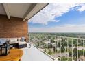 Inviting outdoor balcony with city views, brick wall, and comfortable seating, perfect for relaxation at 955 Eudora St # 1606, Denver, CO 80220