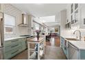 Charming kitchen featuring stainless steel appliances, white subway tiles, and a functional kitchen island at 1686 S Logan St, Denver, CO 80210