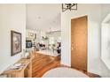 Elegant entryway showcasing hardwood floors that lead into a spacious open-concept living area at 2990 Osceola St, Denver, CO 80212