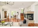 Cozy living room featuring a fireplace, hardwood floors, and staircase to the next level at 2990 Osceola St, Denver, CO 80212