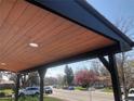 Inviting covered front porch with wood ceiling and modern recessed lighting at 10751 W 66Th Ave, Arvada, CO 80004