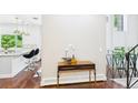 Bright entryway with hardwood floors, adjacent to the staircase and kitchen at 3957 S Peach Way, Denver, CO 80237
